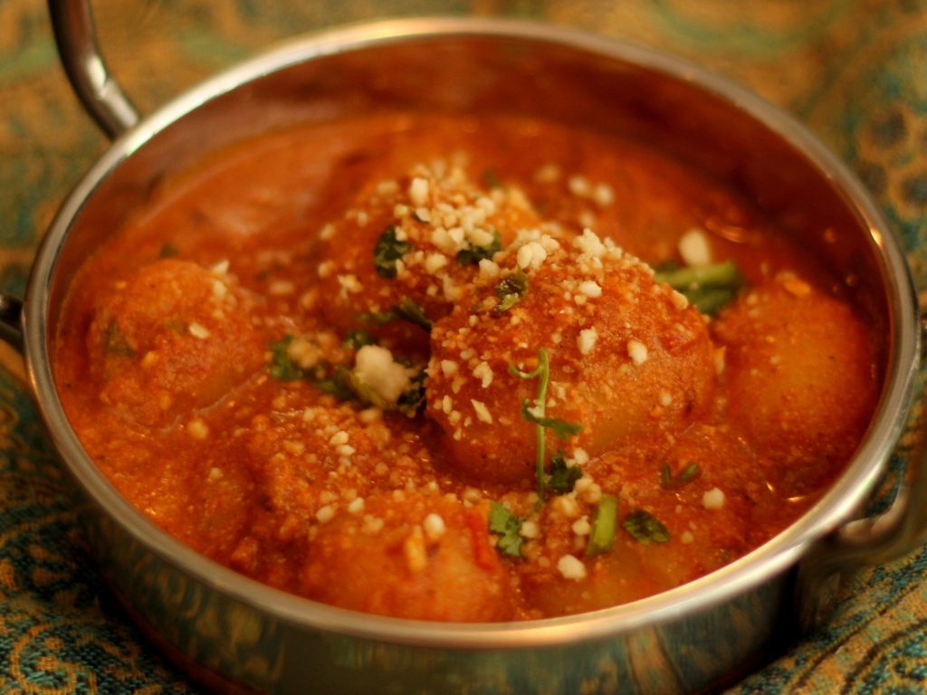 A serving bowl of Kashmiri aloo dum
