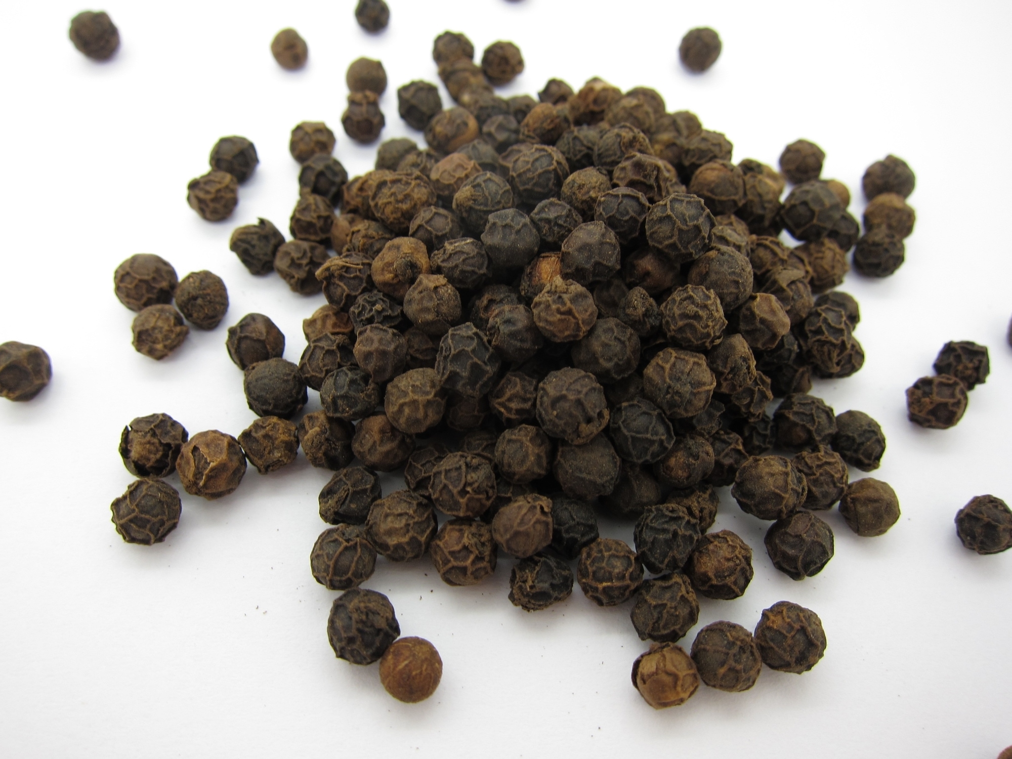 a small mound of black peppercorns
