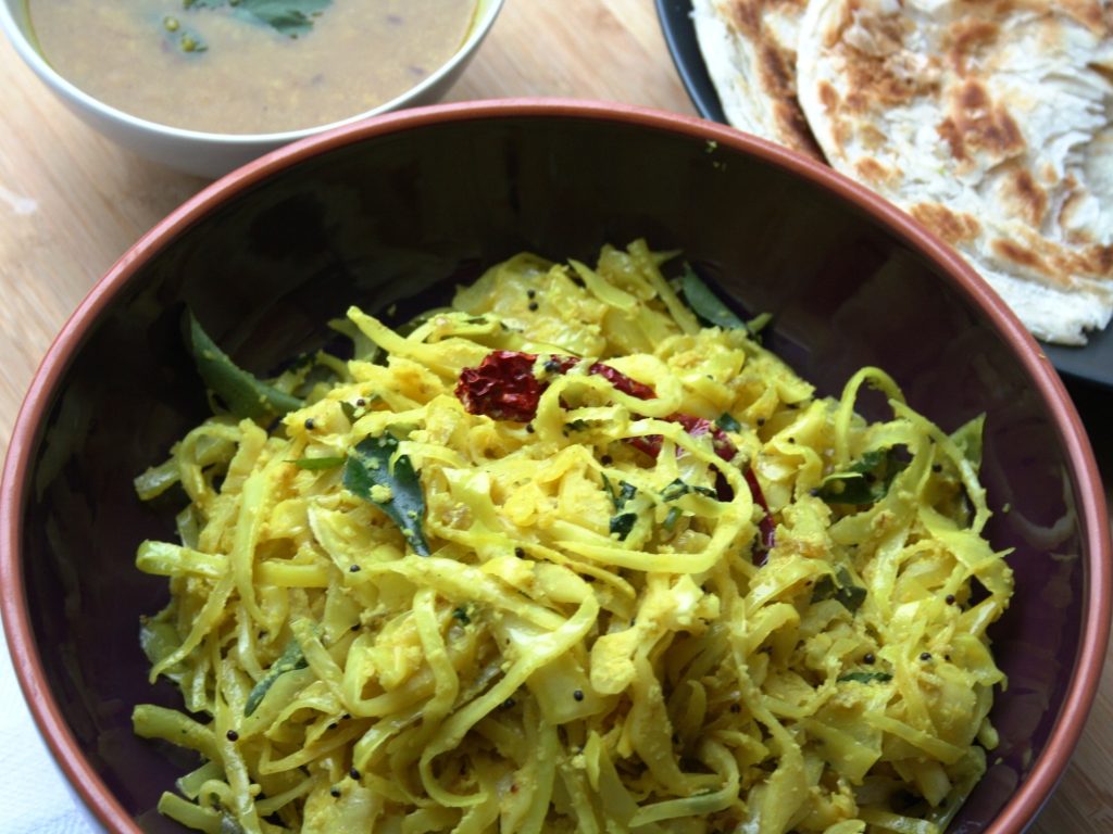 a serving bowl filled with cabbage poriyal