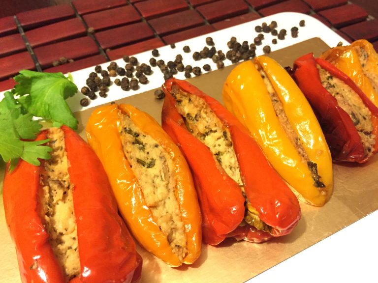 several mini capsicums stuffed with paneer on a platter