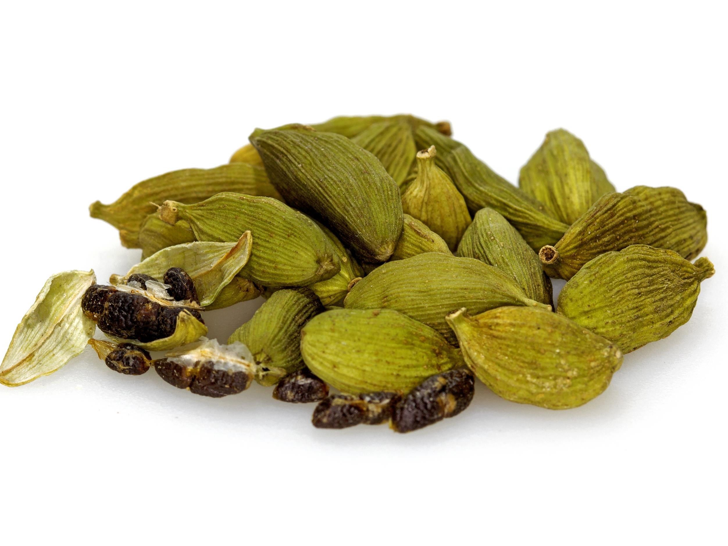 a small pile of green cardamom pods and seeds