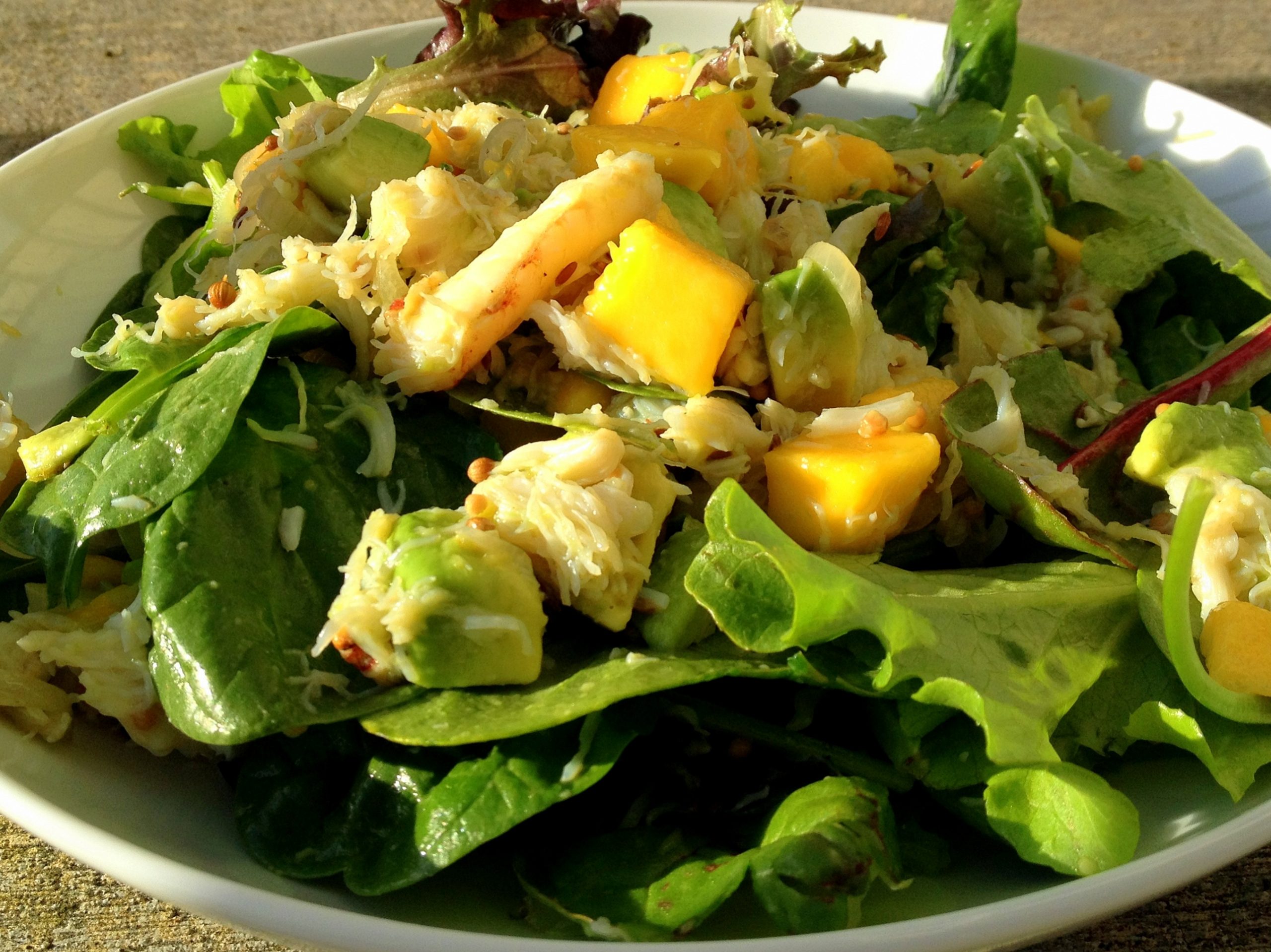 a small platter of crab, mango and coconut salad