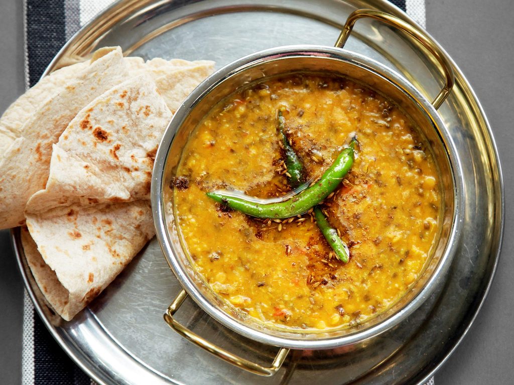 a bowl of Hyderabadi mixed dal on a platter with roti