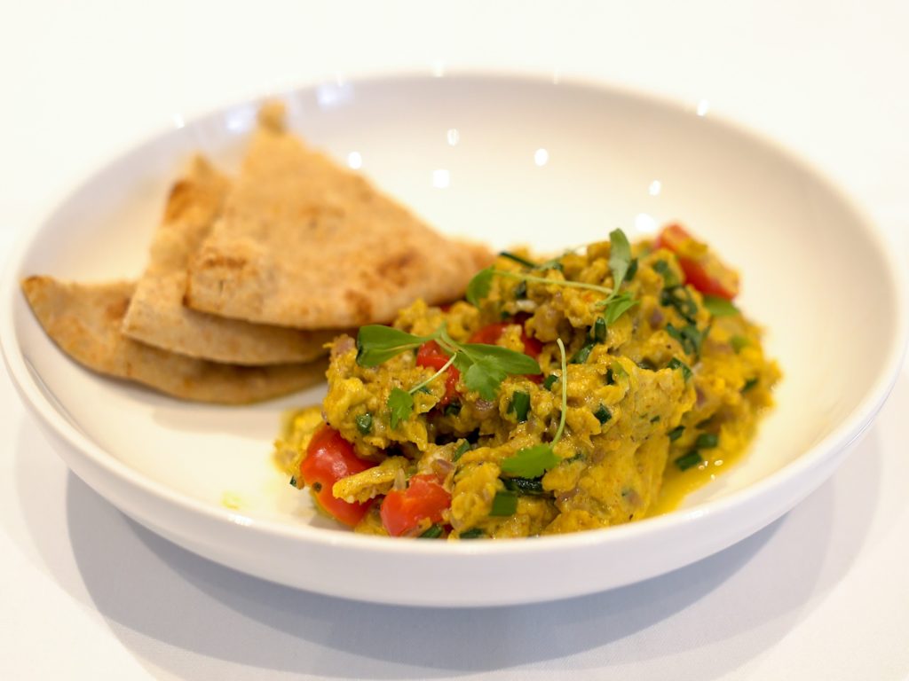 a bowl, with Parsi scrambled eggs and a roti