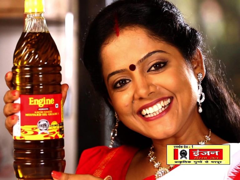 woman holding a bottle of Engine brand mustard oil