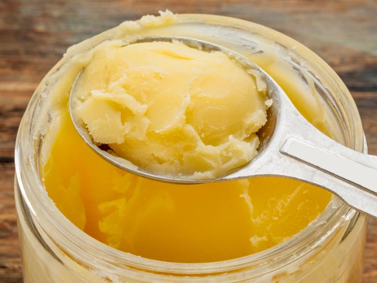 a jar of ghee with a teaspoon