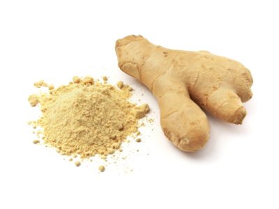 a mound of ginger powder with a fresh root