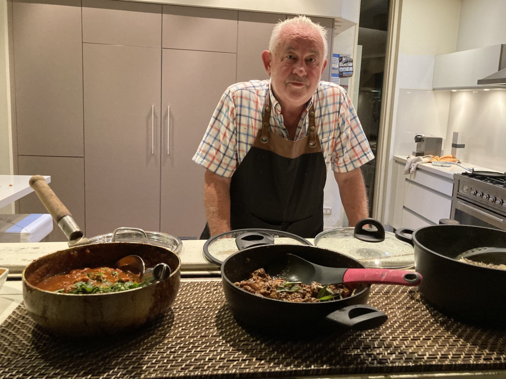carrot raita keith standing behind serving dishes