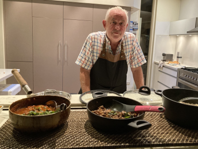 keith standing behind serving dishes
