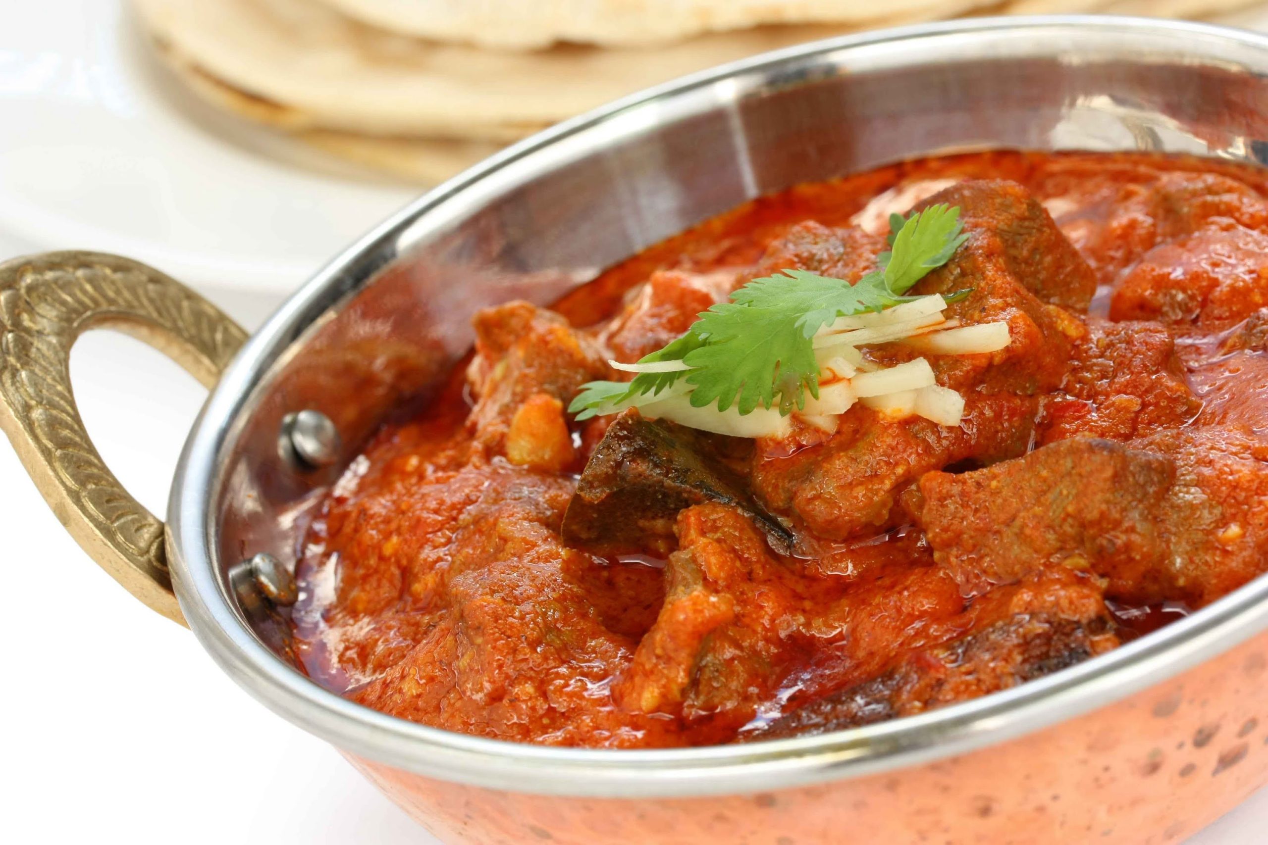 a serving bowl of royal lamb korma