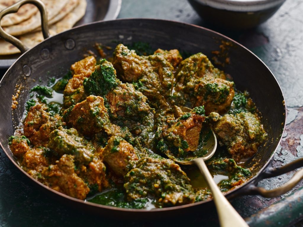 a serving bowl of lamb saag