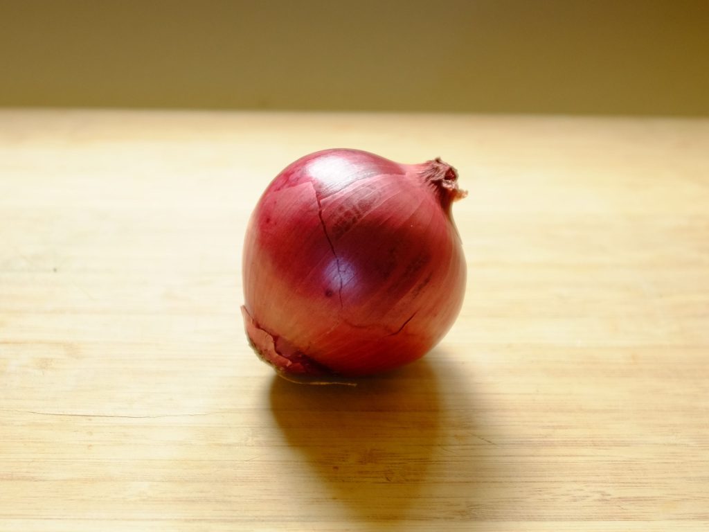 how to chop onions An onion on a chopping board