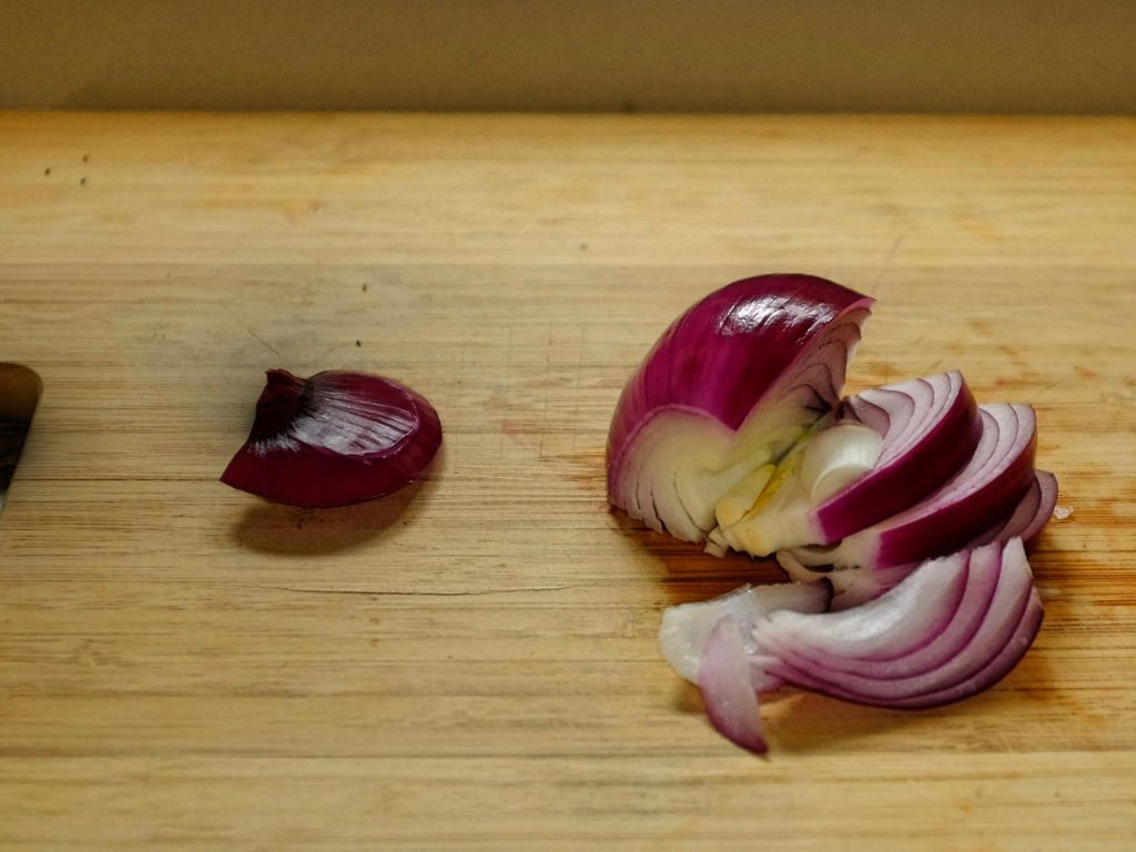 how to slice onions An onion on a chopping board showing cut across along onion