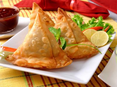 three samosas on a serving plate