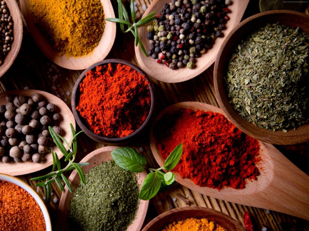 carrot raita spices on spoons and canisters
