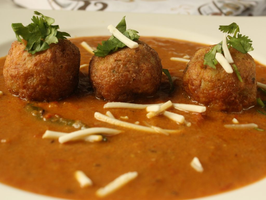 a serving dish of vegetable kofta curry